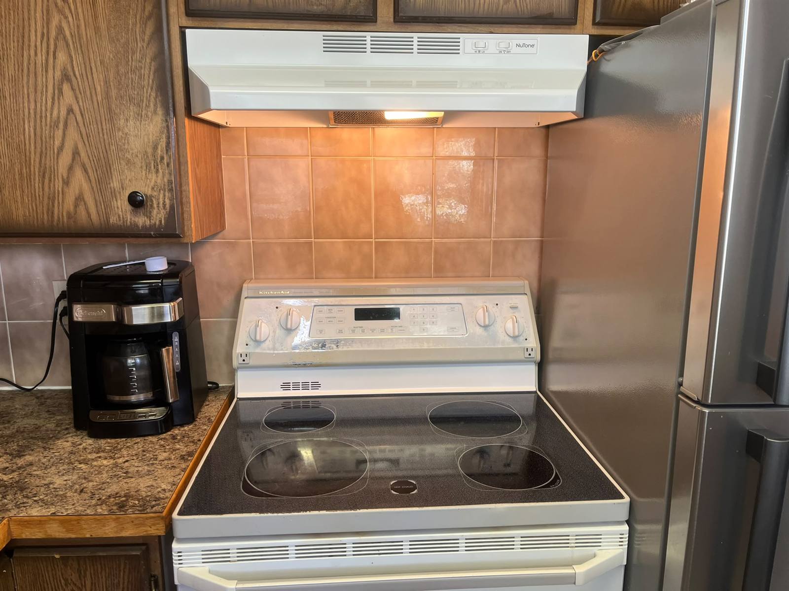 The same stovetop gleaming after the SurfAway clean